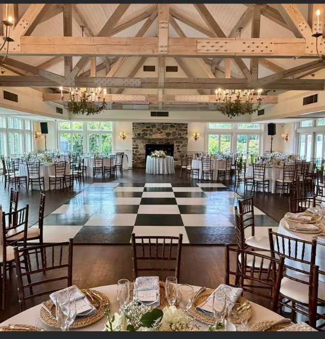 Black and ivory checkered dance floor in a timber-beam reception hall