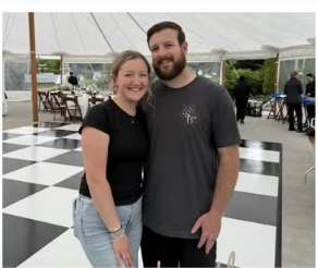 Anna and Josh standing on a black and white checkered dance floor