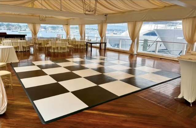Black and ivory checkered dance floor in a waterfront tent